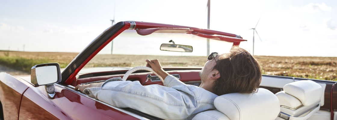 Man enjoying the open road driving a  convertible with the top down