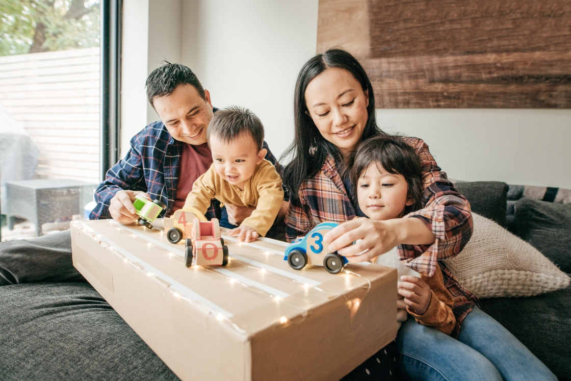 two parents and two children playing with toys