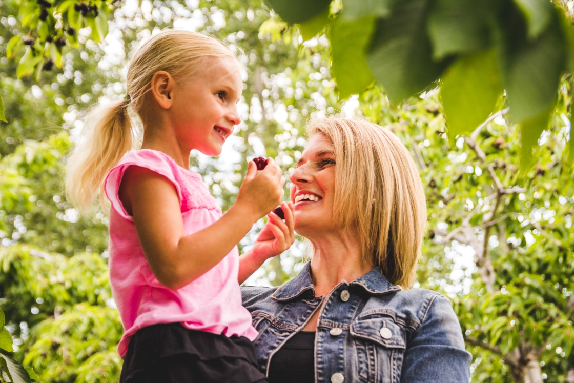 A mother and daughter in an orchard