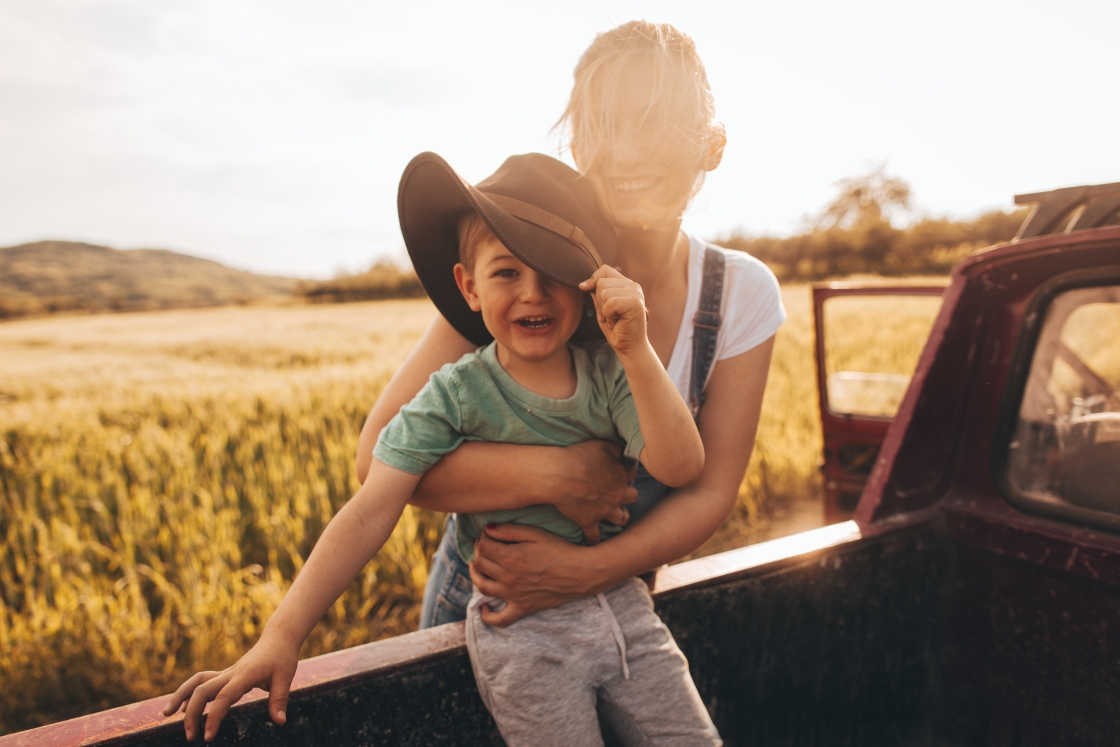 young mother holding her son in a field