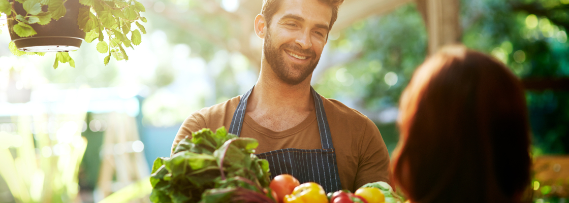 Man selling produce at farmers market