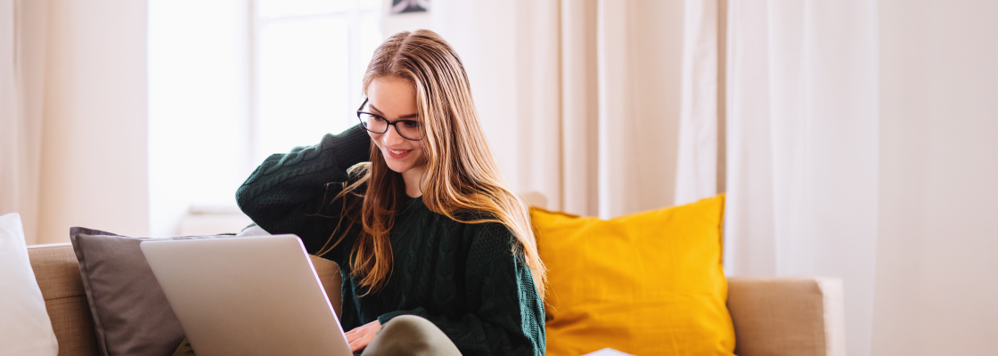 female student on laptop in apartment